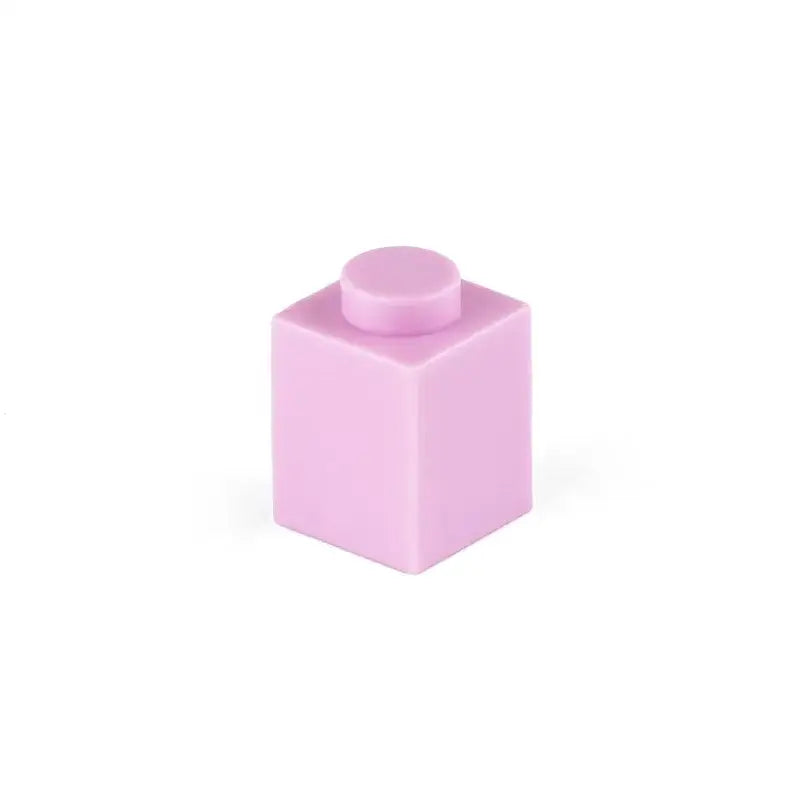 Une brique lego 1x1 rose tendre avec un plot circulaire assorti dans un ensemble 50pcs bloc construction lego