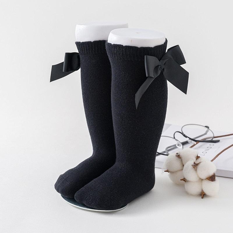 Pair of black socks with bow ties