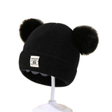 Berretto in maglia con pompon