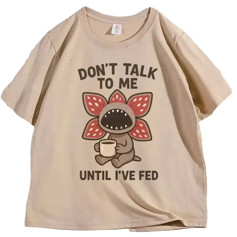 T-shirt beige manches courtes avec illustration cartoon démogorgon humour tenant une tasse et texte humour culture pop
