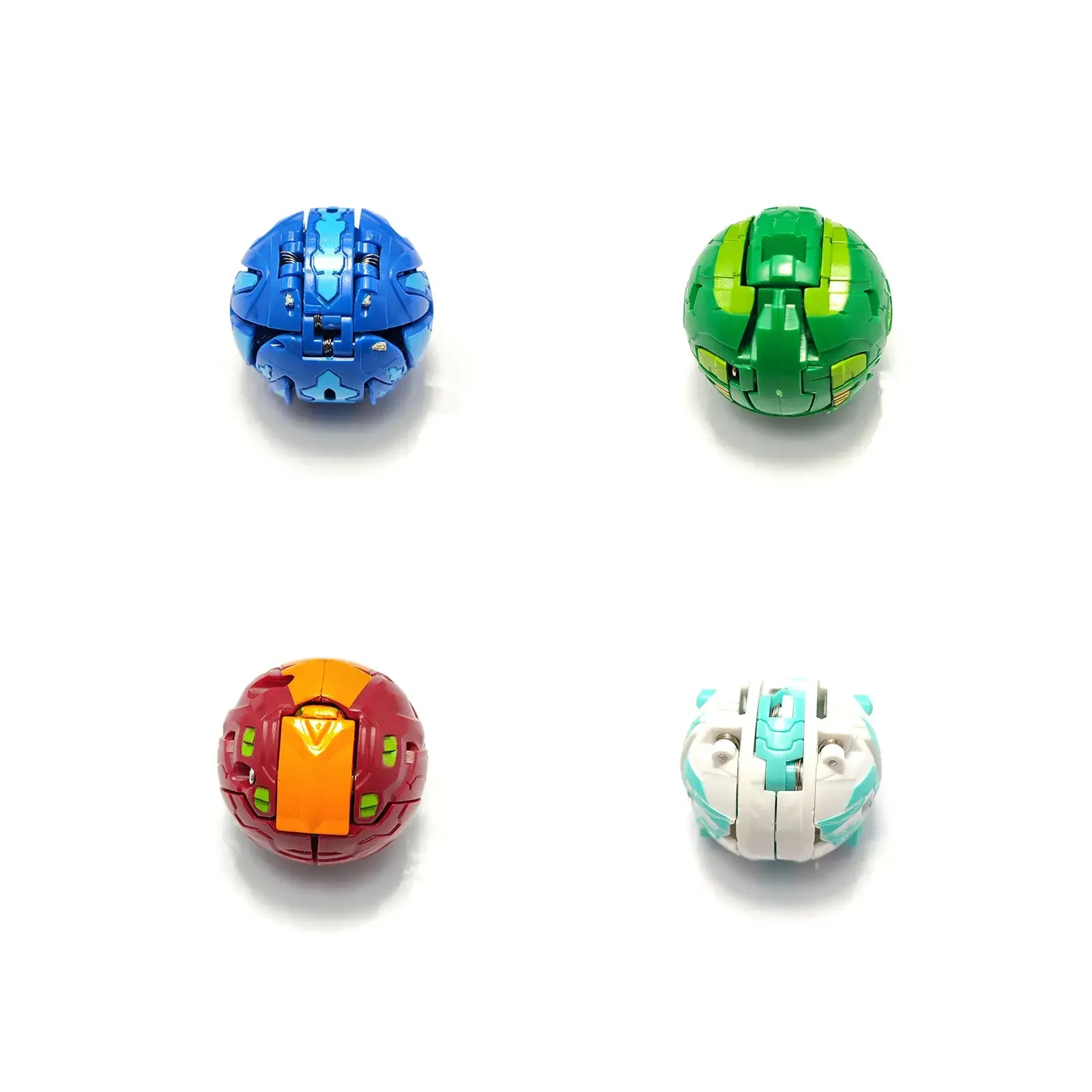 Bakugan jouet boules transformables avec quatre sphères colorées bleu vert rouge-orange et blanc-vert d’eau