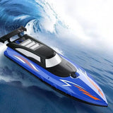 Bateau télécommandé bleu et noir avec décals flammes orange vitesse haute vitesse naviguant sur une vague