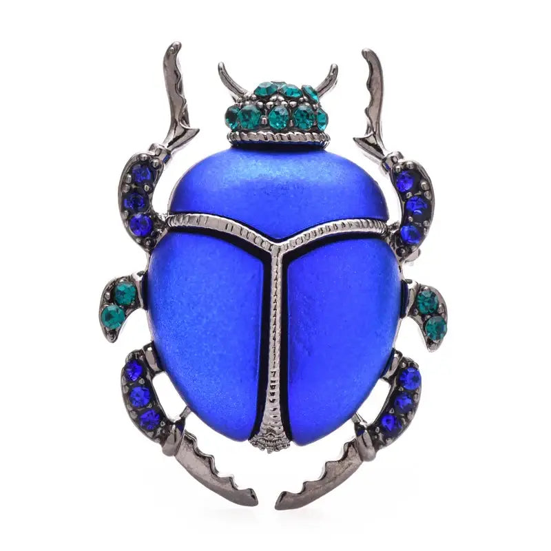 Broche scarabée bleu élégant en métal argenté ornée de pierres émeraude et saphir bijou unique éclatant