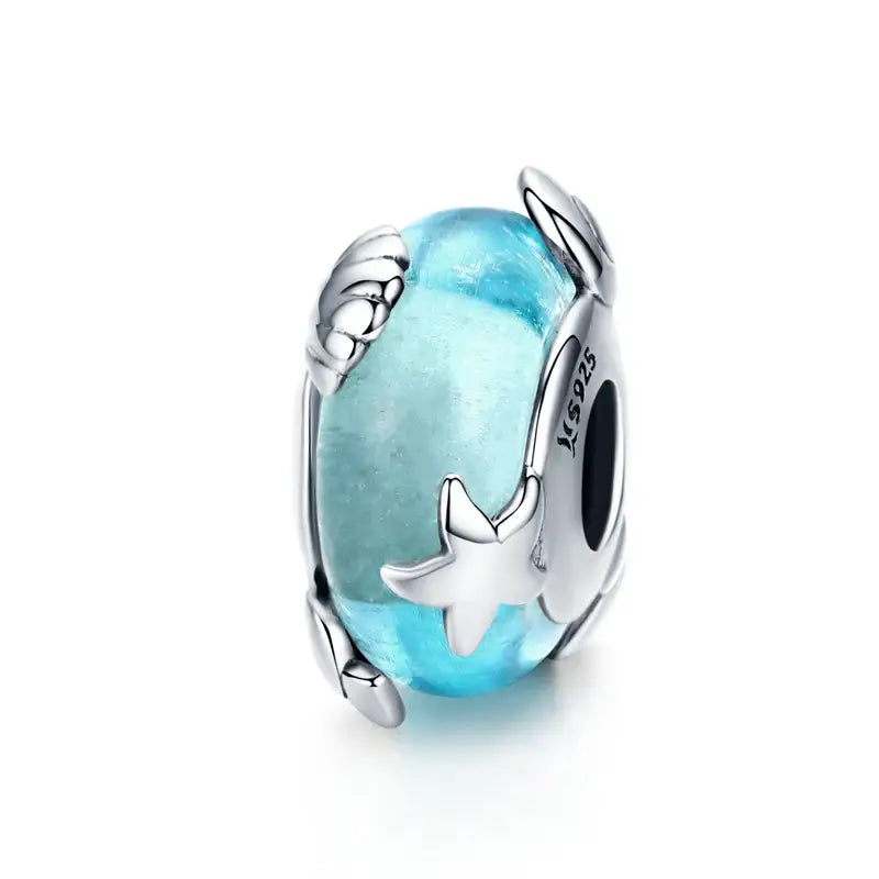 Charme argent bracelet océan en verre bleu translucide avec cadre métal argenté et détails étoiles et feuilles marqué 925