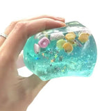Cube anti stress translucide turquoise rempli de confettis coquillages et étoiles jouets à presser cubes anti-stress glace