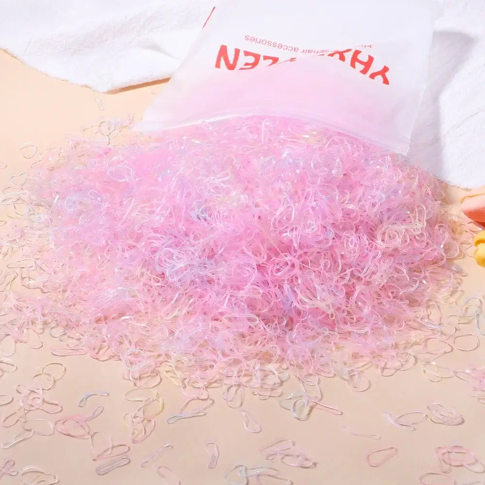 Une pile de 500 élastiques translucides roses et transparents pour bracelets yhxen idéale pour loisirs créatifs et déguisement carnaval