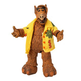 Figurine alf en peluche marron portant une veste jaune vif avec des patchs verts et rouges représentant un alien life form