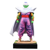 Figurine dragon ball z piccolo vert en cape blanche pantalon violet avec protège-bras orange sur socle noir