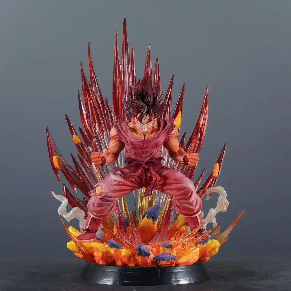 Figurine kaiouken goku dragon ball avec effets d’énergie translucides rouges et orange sur socle noir dynamique