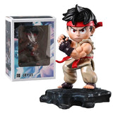Figurine street fighter ryu en position de combat avec bandeau et ceinture rouges sur socle rocheux noir