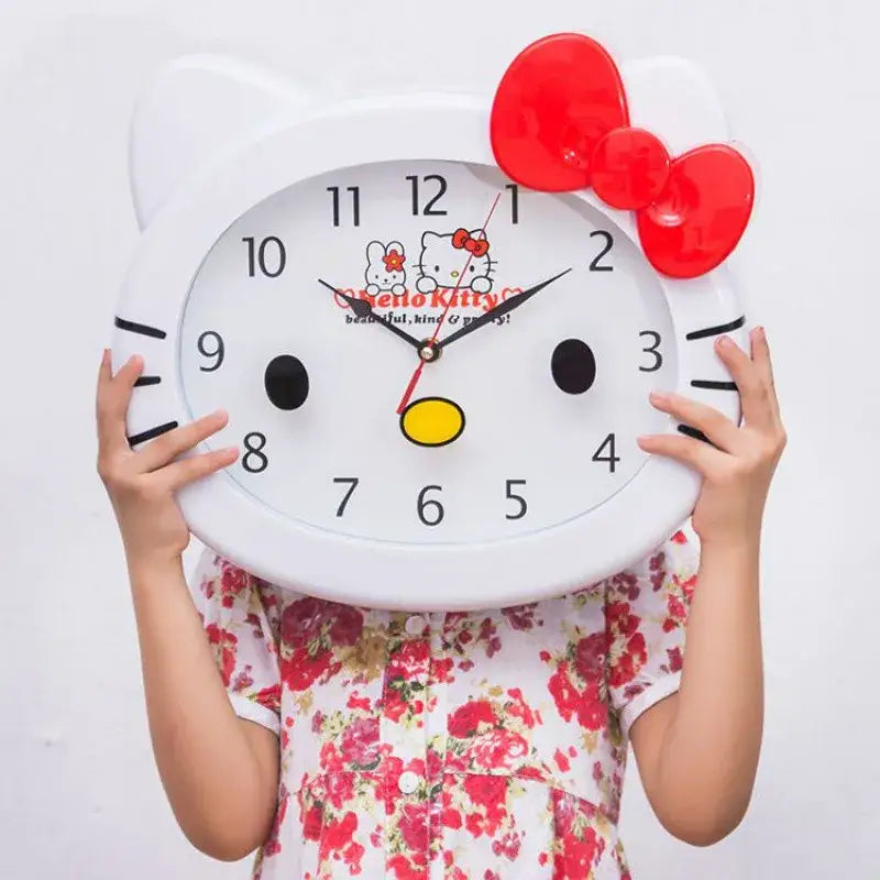 Horloge murale hello kitty blanche avec un noeud rouge yeux et nez noirs et chiffres noirs pour une touche d’adorable murale hello kitty