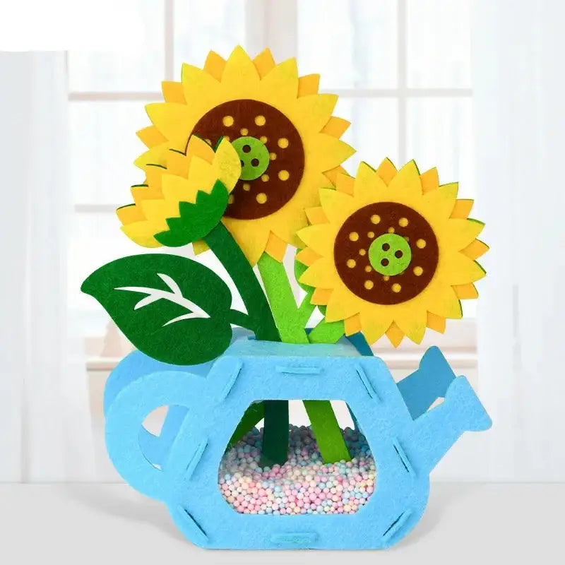 Jeu construction fleurs en pot avec compositions florales uniques de tournesols jaunes en feutre dans un arrosoir bleu