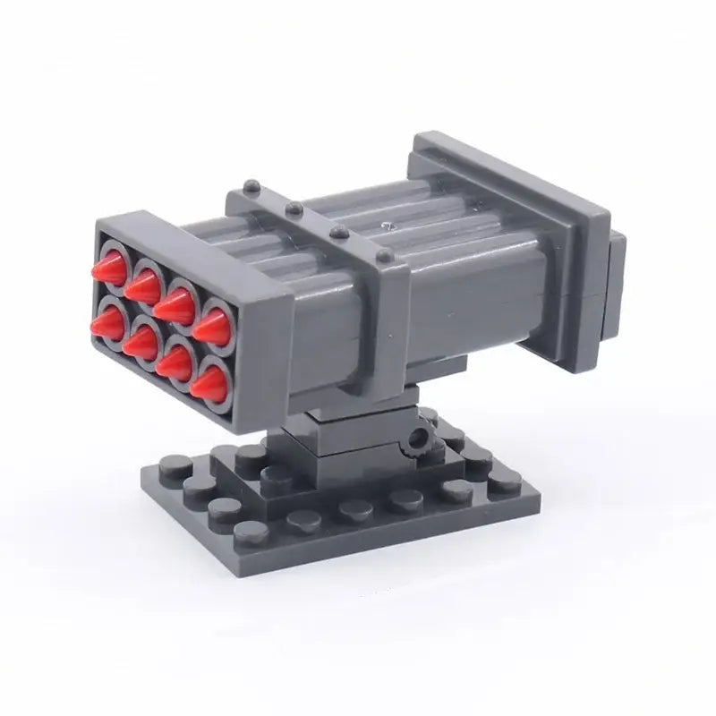 Jouet lego lanceur missiles en gris avec projectiles rouges en forme de cône style lego missiles lego