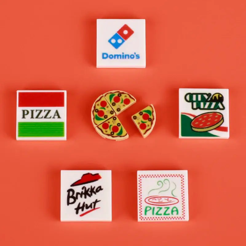 Miniature pizza slice lego moc alimentaire with red tomato and green olive toppings in detailed lego nourriture design