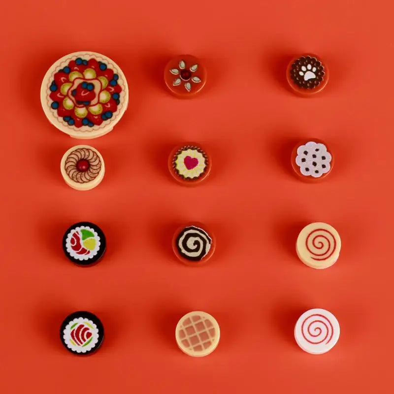 Colorful lego moc alimentaire miniature food-themed fridge magnets on vibrant orange background