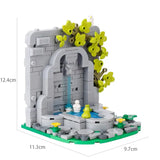 Lego moc medieval fontaine en brique grise avec arche en pierre, eau bleue et fleurs jaunes pour déguisement carnaval