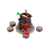 Lego moc medieval avec pot en plastique noir contenant pièces lego alimentaires orange et vert sur support en briques grises et marron
