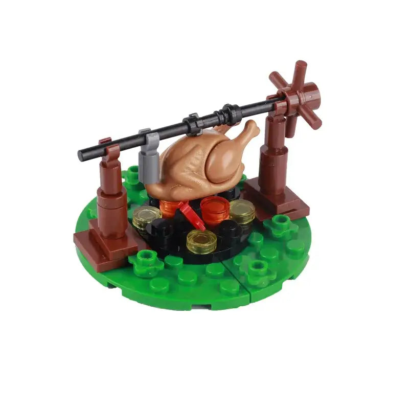 Lego moc medieval avec dinde en lego brun rôtissant à la broche sur un feu de camp pour déguisement carnaval