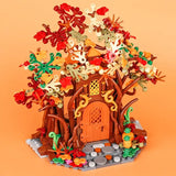 Lego moc medieval arbre maison en lego avec tronc marron porte orange et feuilles rouges vertes jaunes blanches