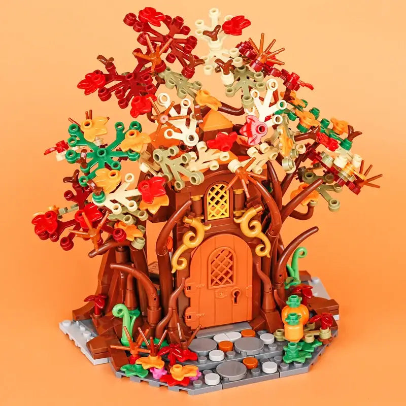 Lego moc medieval arbre maison en lego avec tronc marron porte orange et feuilles rouges vertes jaunes blanches