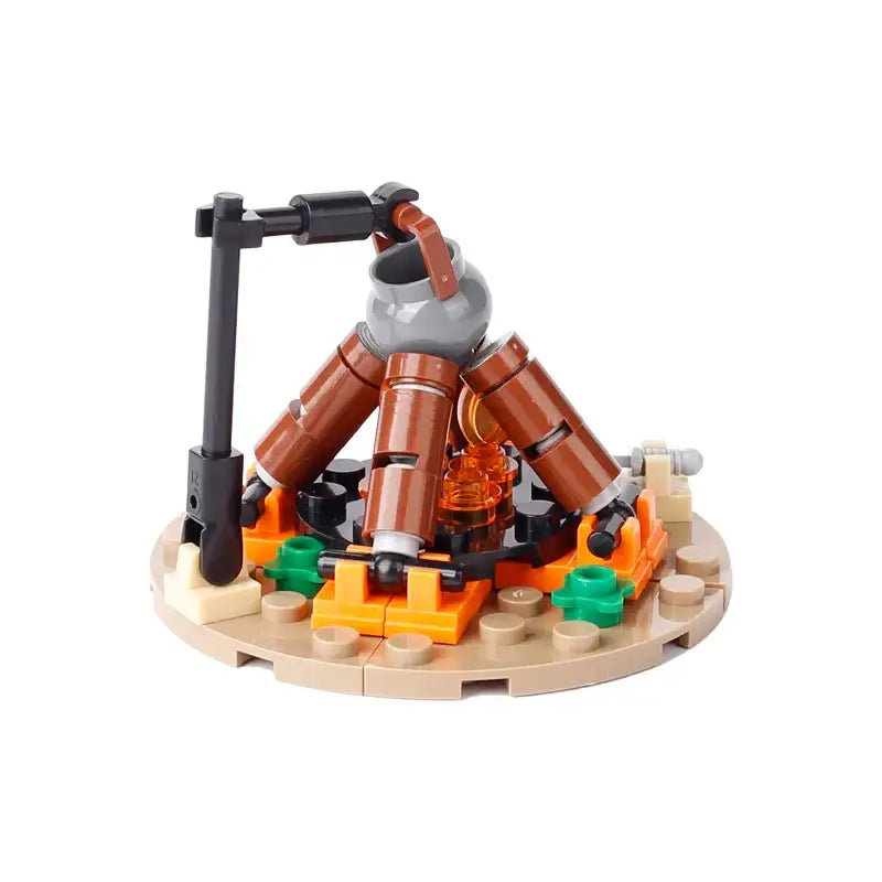 Lego moc medieval avec un feu de camp en bûches marron et flammes orange sur base beige pour déguisement carnaval
