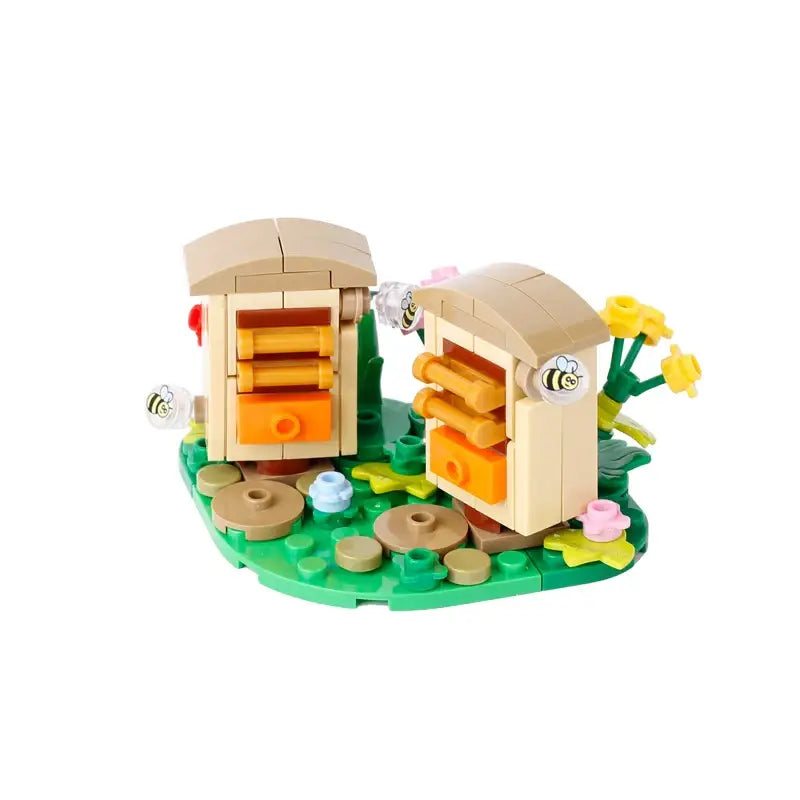 Lego moc medieval avec set d’apiculture beige et orange sur base verte avec fleurs jaunes et abeilles translucides