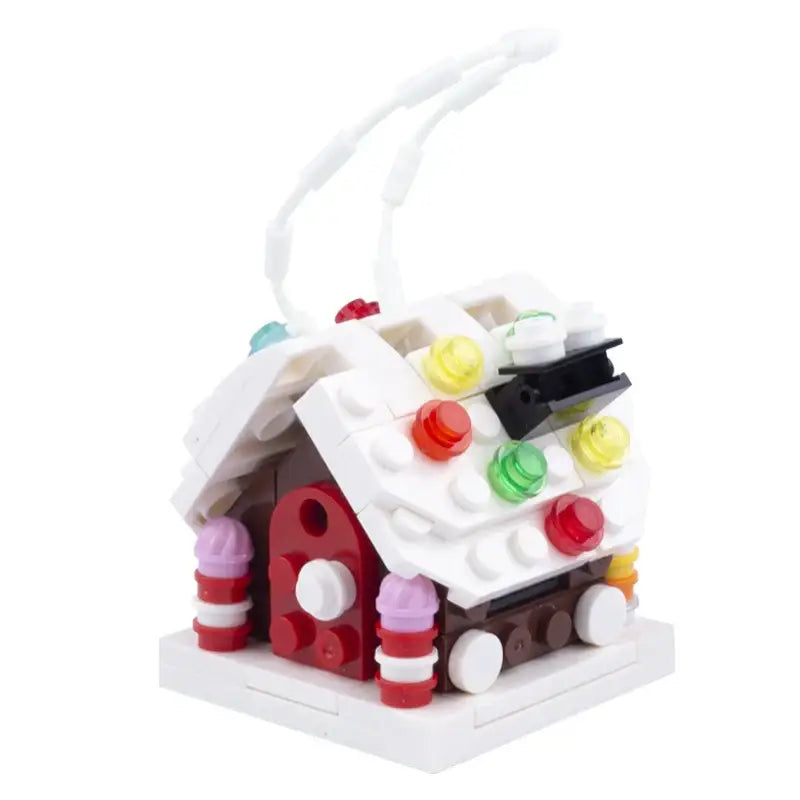 Lego moc décor de noël maison en pain d’épices festive avec toit blanc, bonbons translucides colorés et piliers rayés rouges et blancs en briques lego