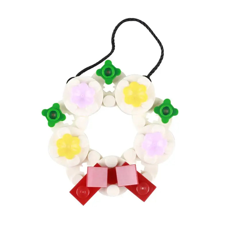 Lego moc décor de noël une couronne de fête en lego colorée avec fleurs blanches jaunes violettes et nœud rouge