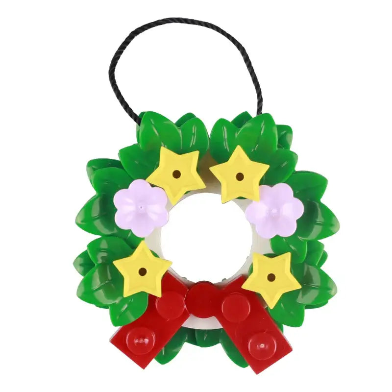 Lego moc décor de noël 2025 ornement guirlande plastique verte avec étoile jaune fleurs lavande et nœud rouge
