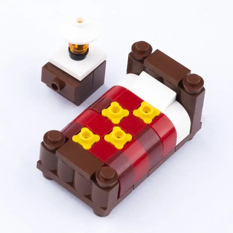 Lego moc lit marron avec couverture tartan rouge et jaune et oreiller blanc accessoire lego meuble pour maison moderne