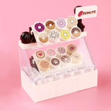 Miniature lego moc stand blanc en acrylique clair présentant des gommes donuts colorées pour lego fruits