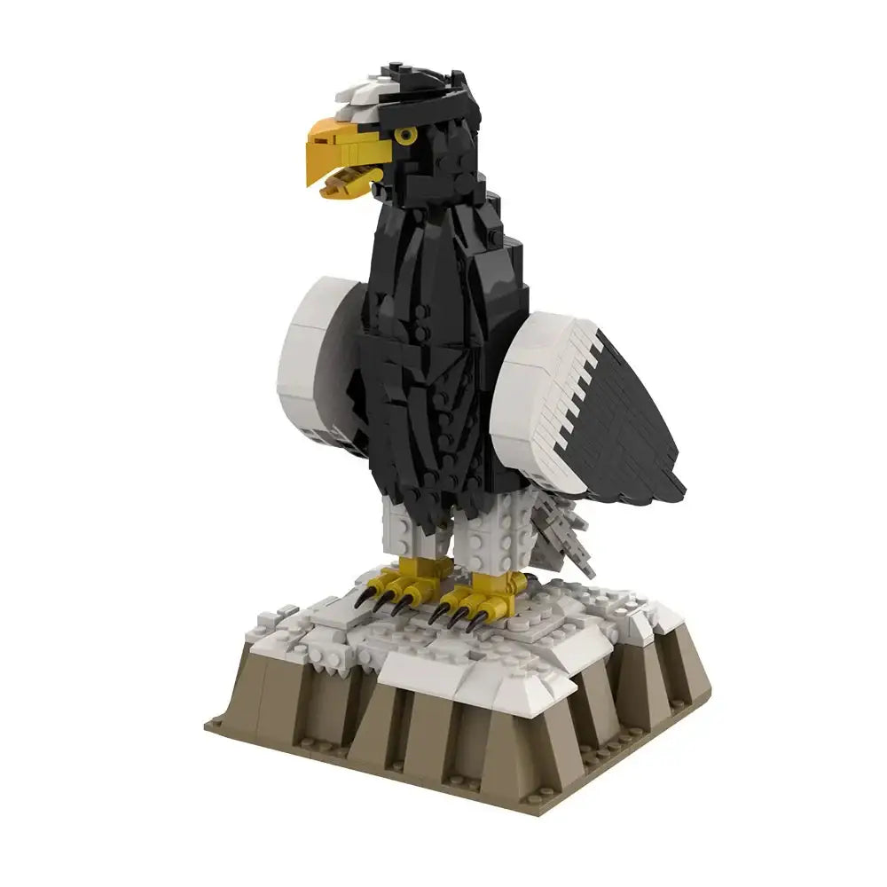 Lego moc oiseaux noir et blanc avec bec, pattes et yeux jaunes sur socle rocheux dans animaux volants