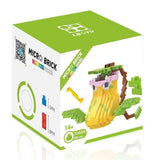 Boîte verte et blanche mini brique figurines pokémon avec modèle dinosaure jaune rose et vert en nano bricks