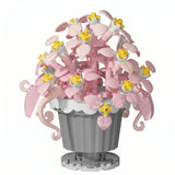 Nanoblock mini fleur en lego rose et jaune dans un pot gris avec bord crénelé, idéal magasins de jouets et déguisement carnaval
