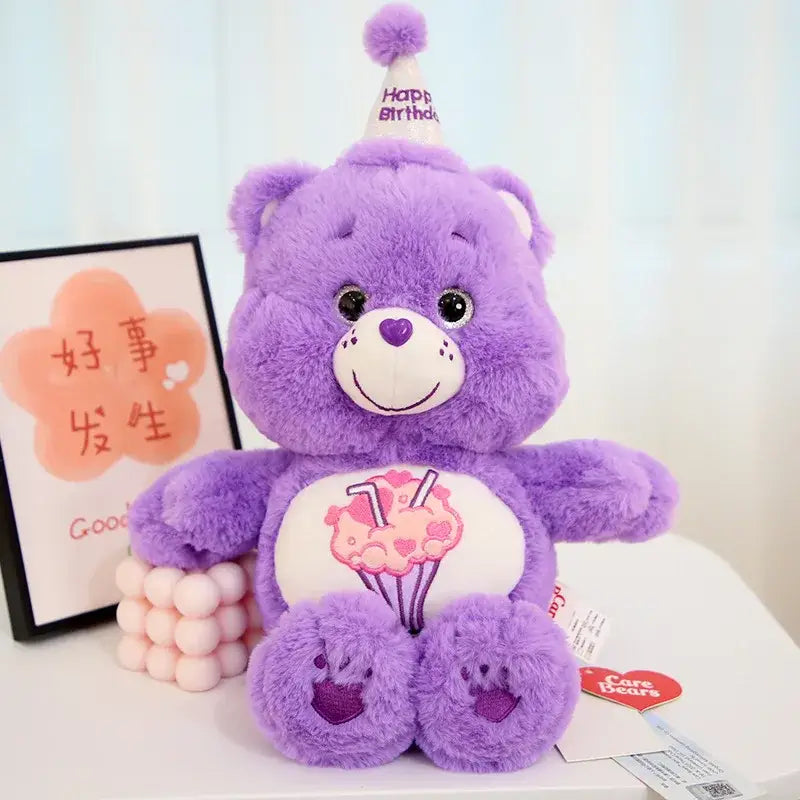 Peluche doudou bisounours calinours violet avec patch ventre blanc cupcake rose et chapeau de fête pour anniversaire