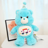Peluche doudou bisounours calinours bleu clair avec note musicale arc en ciel et chapeau de fête sur le ventre