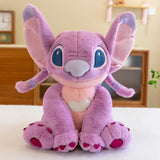 Peluche géante disney stitch angel 80cm coloris violet avec yeux bleus et détails rose assise droite