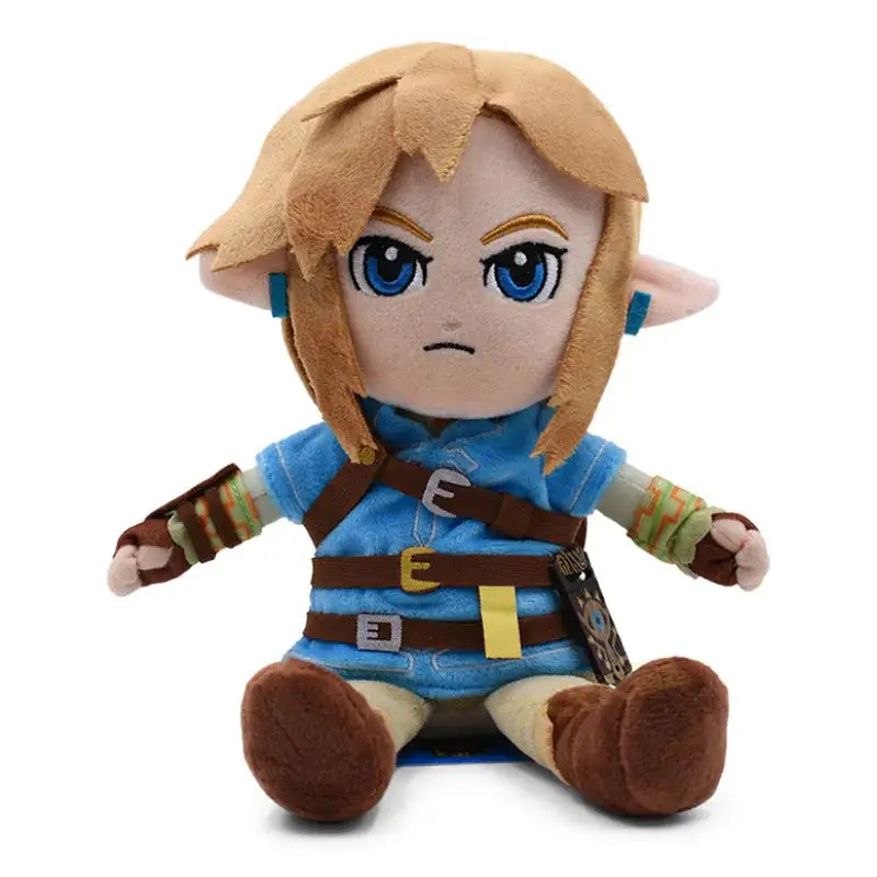 Peluche link zelda botw avec cheveux blonds, yeux bleus et tunique bleue avec ceinture marron du héros légendaire link