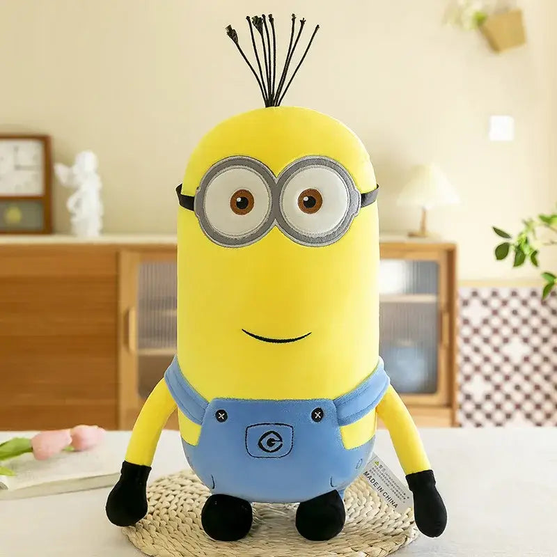 Peluche minion jaune en salopette bleue avec gants noirs dans peluches minions personnages anime 30cm découvrez l’univers ludique