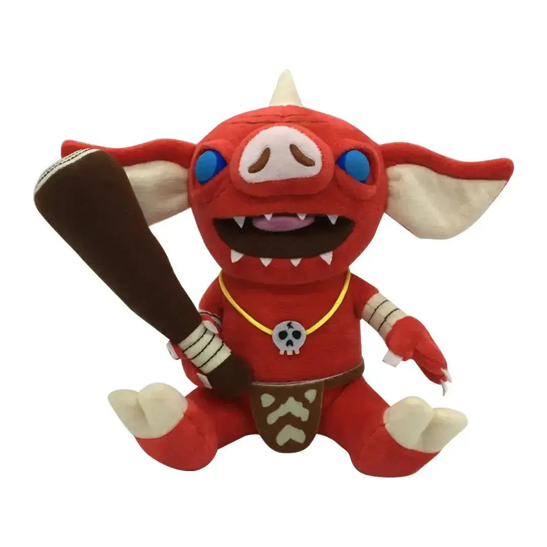Peluche zelda botw bokoblin korok rouge aux yeux bleus avec crocs blancs et collier jaune à pendentif crâne