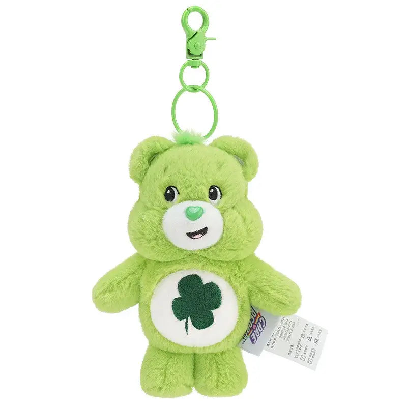 Porte-clé peluche bisounours vert doux avec care bear souriant et patch ventre blanc avec trèfle vert foncé