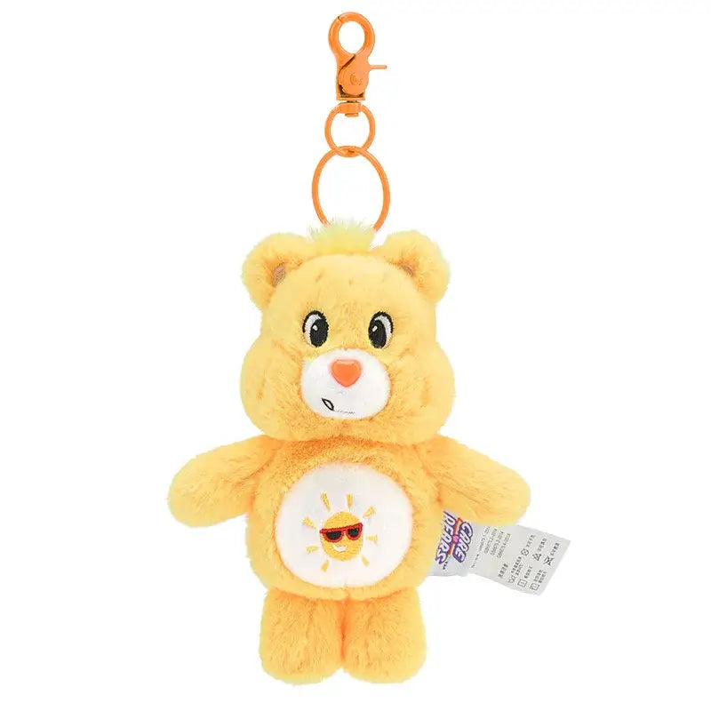 Porte-clé peluche bisounours jaune avec ventre blanc décoré d’un soleil souriant portant des lunettes de soleil