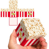 Boîte de pop-corn rubik’s cube rouge et blanche avec motif de grains de maïs et branding pop.com pour cube cornet revisité