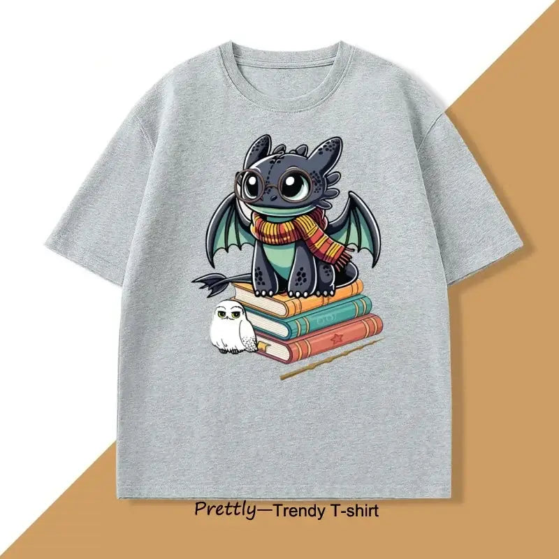 Gray heathered cotton t-shirt anime featuring funny dragon toothless with scarf sitting on books with owl and wand nearby