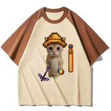 T-shirt minecraft unisexe crème à manches marron avec chat pixel art portant un chapeau jaune et objets jeux vidéo