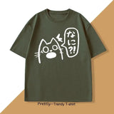 T-shirt unisexe olive vert coton avec chat anime blanc et texte japonais dans bulle, couleurs tendance